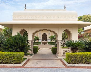 Elegant gazebo at The Oberoi Sukhvilas, surrounded by lush greenery