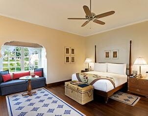 Elegant bedroom at The Oberoi Sukhvilas, featuring plush furnishings and decor