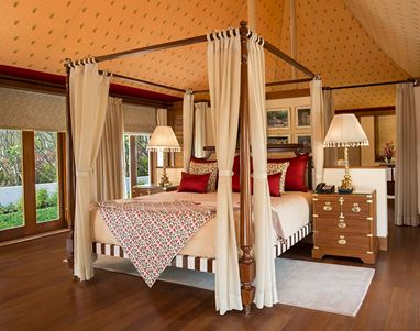 Four-poster bed in a luxurious room, Oberoi Sukhvilas, Siswan Forest Resort.