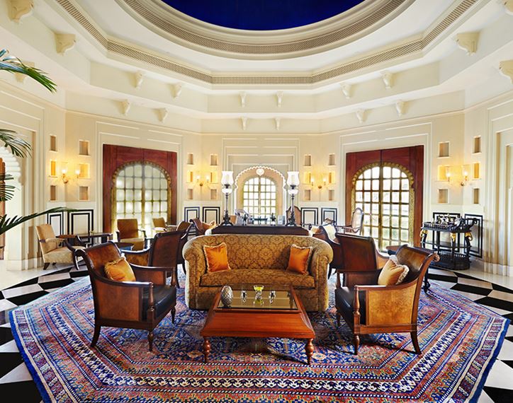 Promenade dining space at The Oberoi Sukhvilas, designed with colonial elegance and surrounded by lush greenery