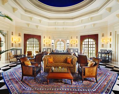 Promenade dining space at The Oberoi Sukhvilas, designed with colonial elegance and surrounded by lush greenery