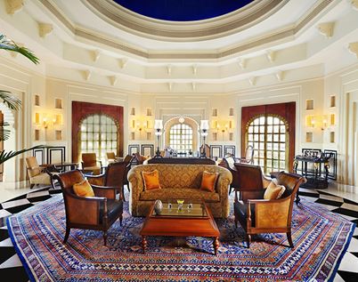 Promenade dining space at The Oberoi Sukhvilas, designed with colonial elegance and surrounded by lush greenery
