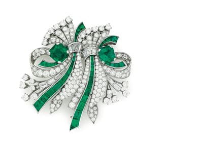 An emerald and diamond double clip brooch by Raymond Yard