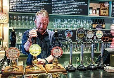 The landlord of the Drunken DuckInn pulling apint of localreal ale