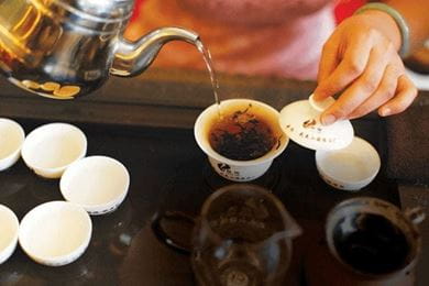 Wang Shunming, producer of Da Hong Pao tea, pours a cup of the rare brew