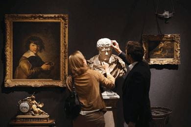 At a Christie’s auction, people admire a marble bust from the collection of Professor Sir Albert Richardson 