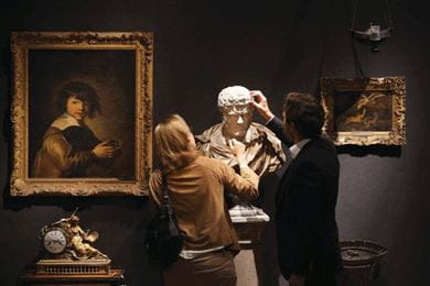 At a Christie’s auction, people admire a marble bust from the collection of Professor Sir Albert Richardson