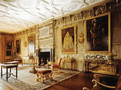 View of the ballroom, at Knole, Sevenoaks, Kent in England, featuring a decorative chimney piece, gilded furniture and plasterwork ceiling