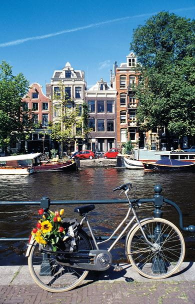 A cycle parked along the Keizersgracht canal in the city