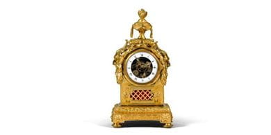 A gilt-bronze mantel clock with skeletonized dial, Louis XVI, circa 1785, auctioned by Sotheby’s