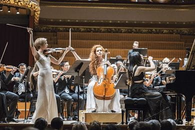 Cellist Camille Berthollet, violinist Julie Berthollet and pianist Melodie Zhao play in the UN Orchestra concert for the International Organization for Migration