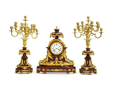 A Louis XVI style gilt bronze mounted rouge griotte marble clock garniture, Paris, 19th century. Courtesy, Sotheby's.